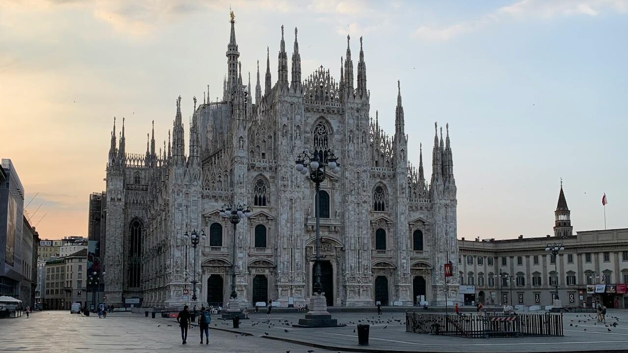 Duomo de Milão: Guia Completo para Sua Visita Inesquecível 1 Foto em dia Claro do Duomo di Milano, poucas pessoas andando na praça em frente.